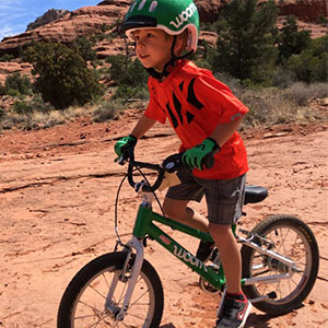 Child on a dirt road riding a bike